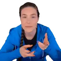 a woman in a blue jacket is making a gesture