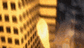 a blurred image of a building with a candle in the foreground .