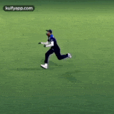 a man in a blue jersey is running on a field .