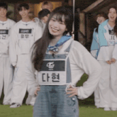 a girl wearing overalls and a name tag that says twice