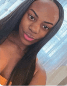 a woman with long hair is taking a selfie with her eyes closed