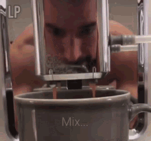 a man is drinking coffee from a machine that says " mix "