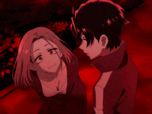 a man and a woman are standing next to each other in a dark room