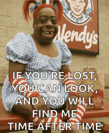 a wendy 's sign is behind a woman
