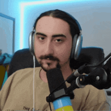 a man with a beard wearing headphones and a shirt that says the on it