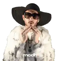 a man wearing a fur coat and a hat has the word mcdh on the bottom right