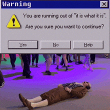 a man is laying on the ground under a warning screen