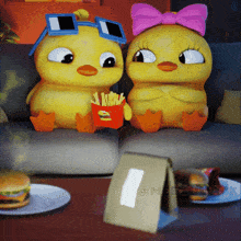 two cartoon ducks are sitting on a couch with a bag of mcdonald 's french fries in front of them