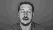 a man with a beard is looking up at the camera