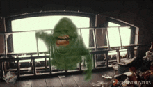 a ghostbusters animated gif of slimer flying through the air