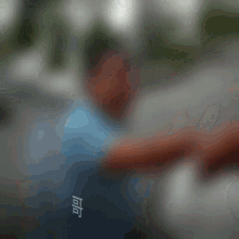 a blurry picture of a man with chinese writing on the back of his shirt