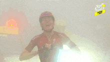a man wearing a helmet and a red shirt that says tutto on it