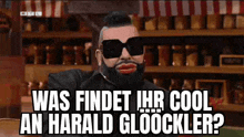 a man with a beard and sunglasses is wearing a fake face and asking a question .