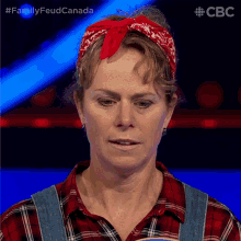a woman wearing overalls and a red bandana is on a tv show