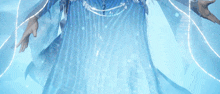 a woman in a blue dress is surrounded by glowing lines