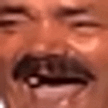 a close up of a man 's face with a mustache and tears coming out of his eyes .