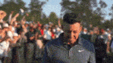 a man is standing in front of a crowd of people .