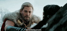 a man in a fur coat is talking to another man who is missing an arm .