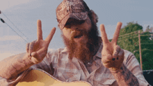 a man with a beard wearing a hat that says alabama on it