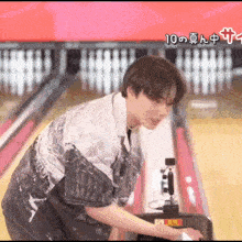 a man in a bowling alley with the number 10 written on the bottom