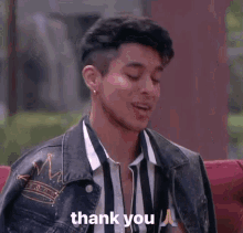 a man sitting on a couch with a thank you message