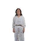 a woman in a white shirt and white pants is dancing in front of a white background