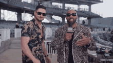 two men standing next to each other with a microphone that says a & w