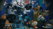 a video of a robot surrounded by stuffed animals with the words " vido al " on the bottom