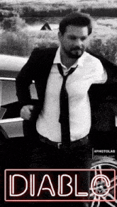 a man in a suit and tie is standing in front of a car with the word diablo on the bottom