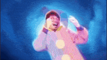a man in a clown costume is dancing in the dark