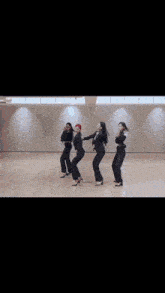 a group of women in suits and heels are dancing in a room