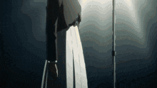 a person in a black jacket and white skirt is standing in the dark