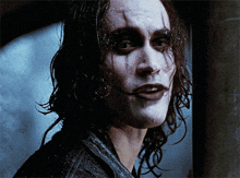 a close up of a person 's face with wet hair and makeup
