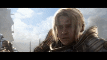 a woman with blonde hair and a sword in her hand