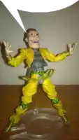 a toy figure with a speech bubble behind him
