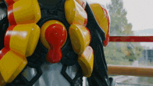 a close up of a yellow and red object with a red center