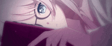a girl with glasses is laying down and looking at a cell phone