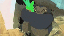 a cartoon character is holding a green object in his hand while standing on a wooden floor .