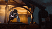 a man is kneeling down in front of a building in a dark room