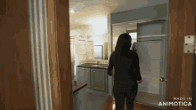 a woman is standing in a room with the words made in animatica on the bottom