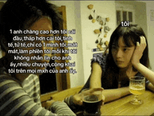 a man and a woman are sitting at a table with a glass of beer in front of them .
