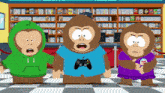 three monkeys are standing in front of a bookshelf and one has a shirt that says fun