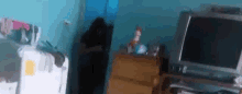 a blurry picture of a room with a tv and dresser