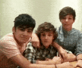 a group of young men are sitting at a table .