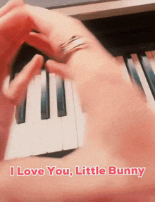 a person playing a piano with the words " i love you little bunny " above them