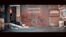 a storehouse and depository with graffiti on the side of it