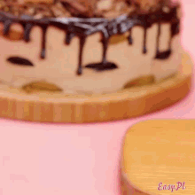 a cake sitting on a wooden cutting board with easy pl written on the bottom