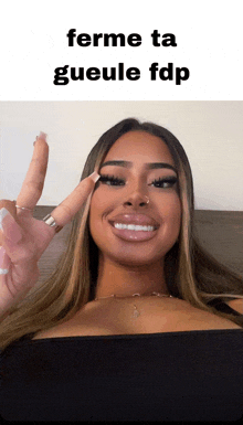 a woman giving a peace sign with the words ferme ta gueule fdp