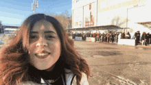 a woman stands in front of a building with a sign that says ' a ' on it