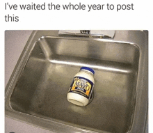 a jar of mayonnaise sits in a kitchen sink